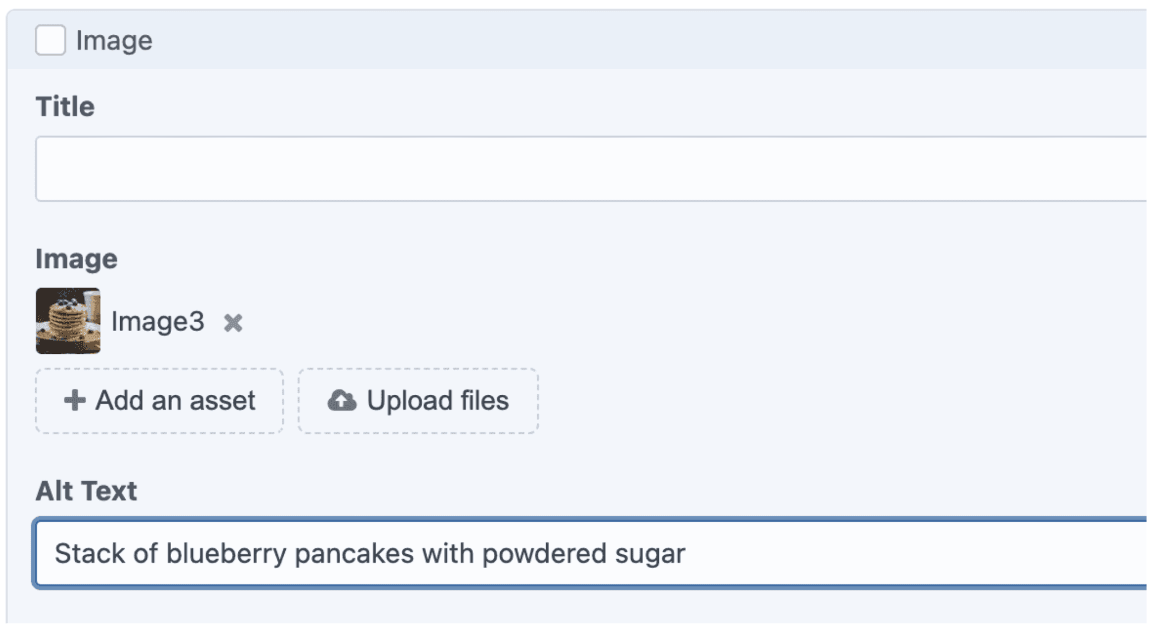 Stack of blueberry pancakes with powdered sugar