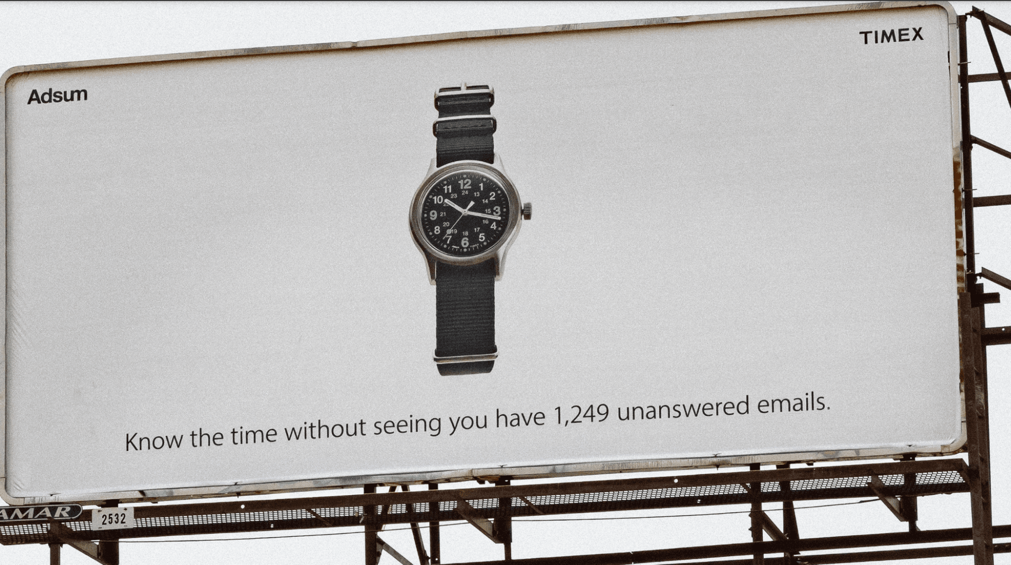 A billboard selling a Timex watch includes the statement "Know the time without seeing you have 1,249 unanswered emails."