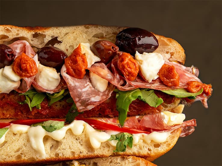 Overfilled sandwich with layers of ingredients representing how website templates organize content.